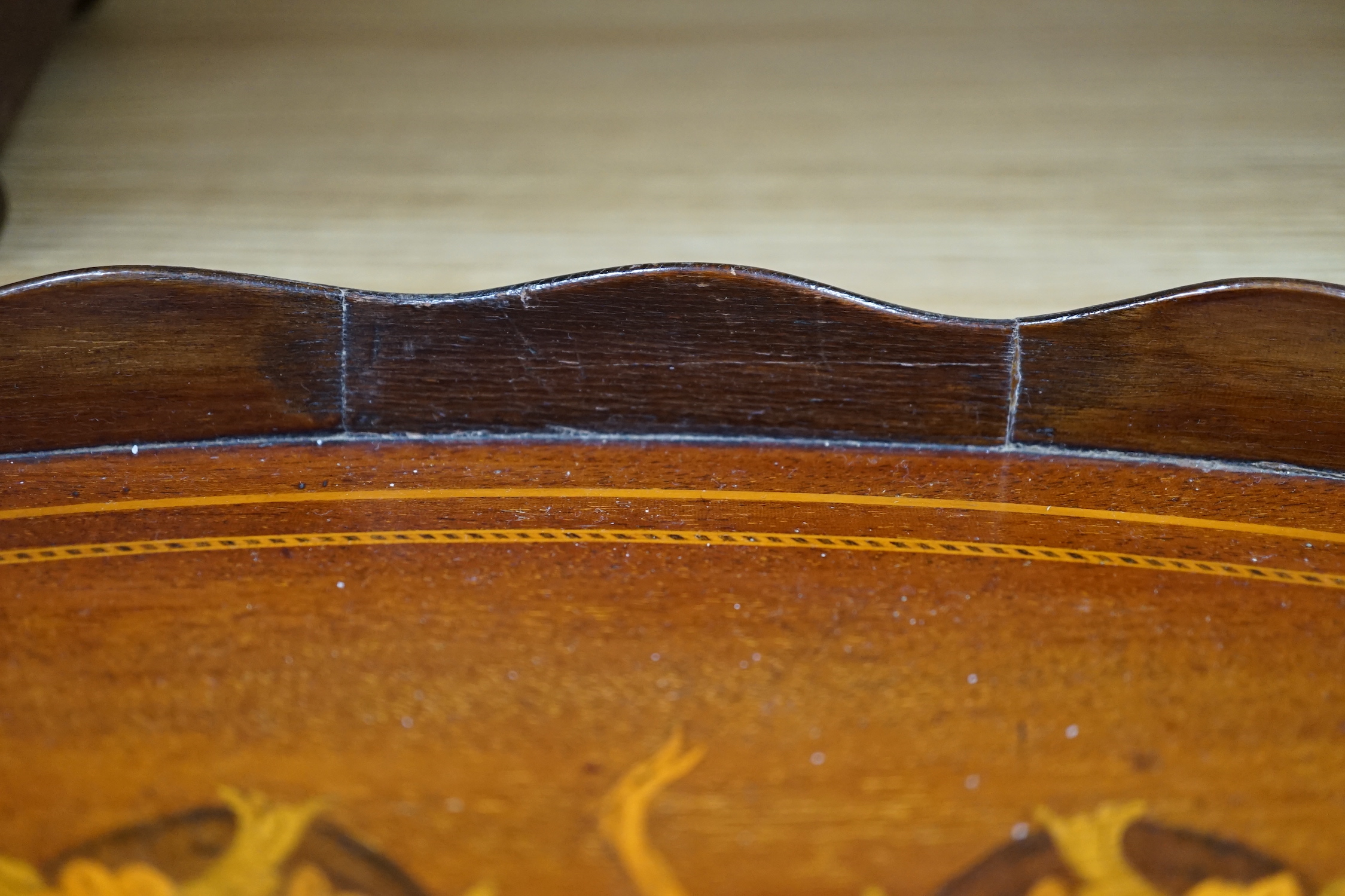 An Edwardian marquetry inlaid oval mahogany two handled tea tray, 63cm